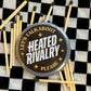 Matches with a round metal token labeled 'Let's talk about heated rivalry please' on a checkered background