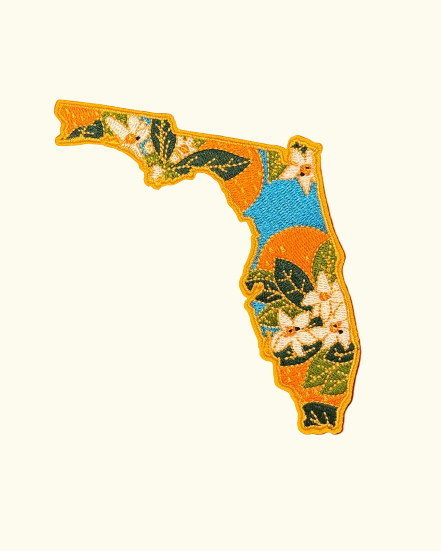 Embroidered patch of Florida with floral design on a white background