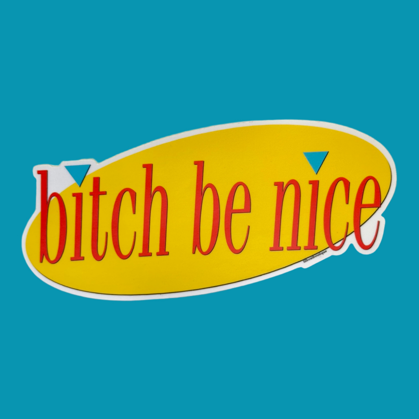 Sticker with 'bitch be nice' text on a yellow surface with white border. Text is red. 
